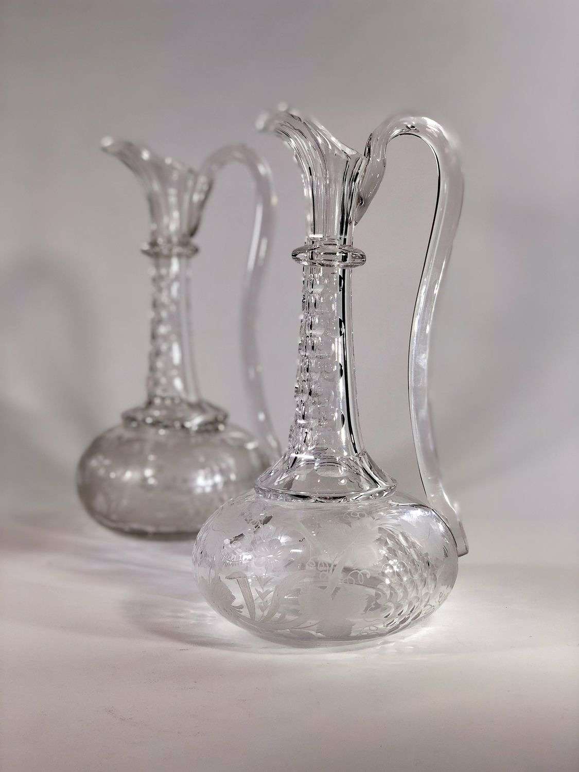 Smart pair of Georgian etched glass claret jugs