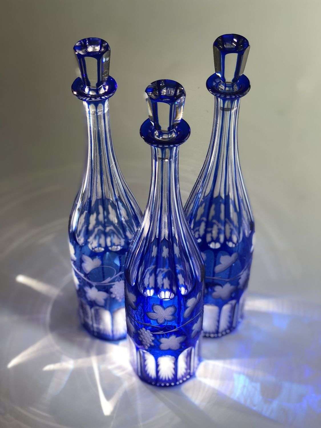 Trio of super tall 19th Century Bohemian cut to clear decanters