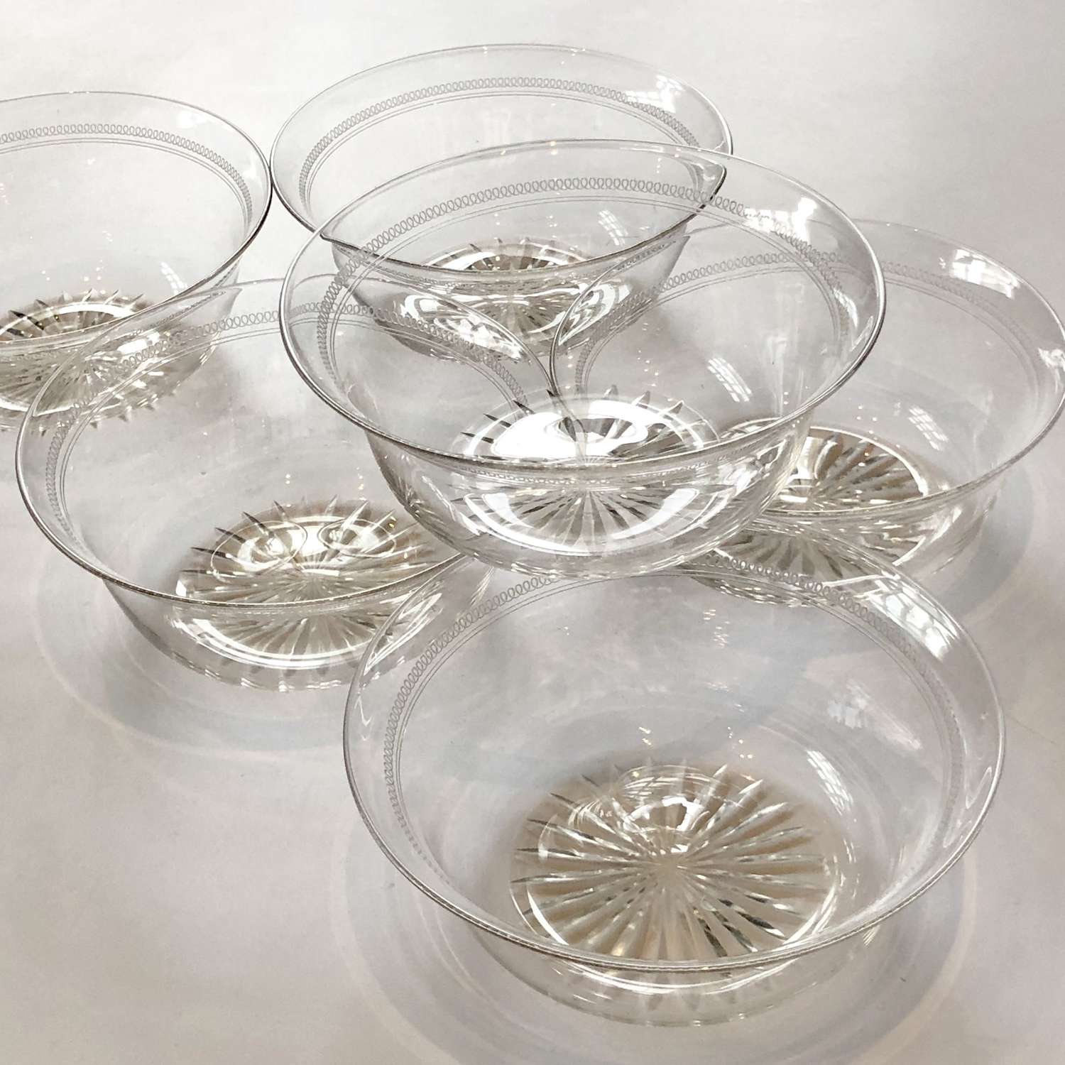 Set of six Edwardian cut glass and etched bowls