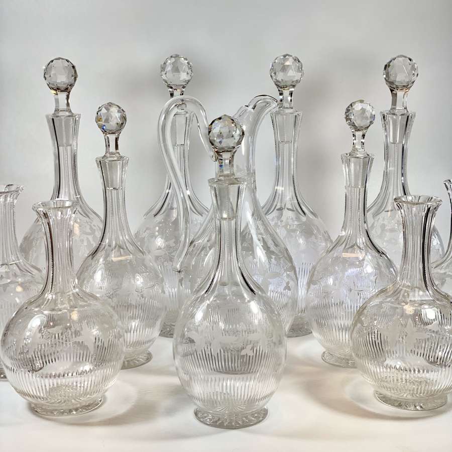 Rare suite of 12 Victorian vine etched crystal decanters