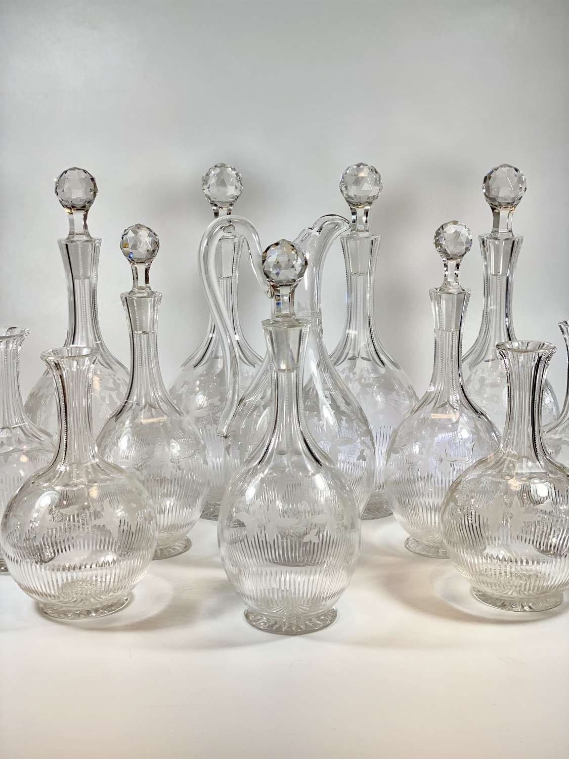 Rare suite of 12 Victorian vine etched crystal decanters
