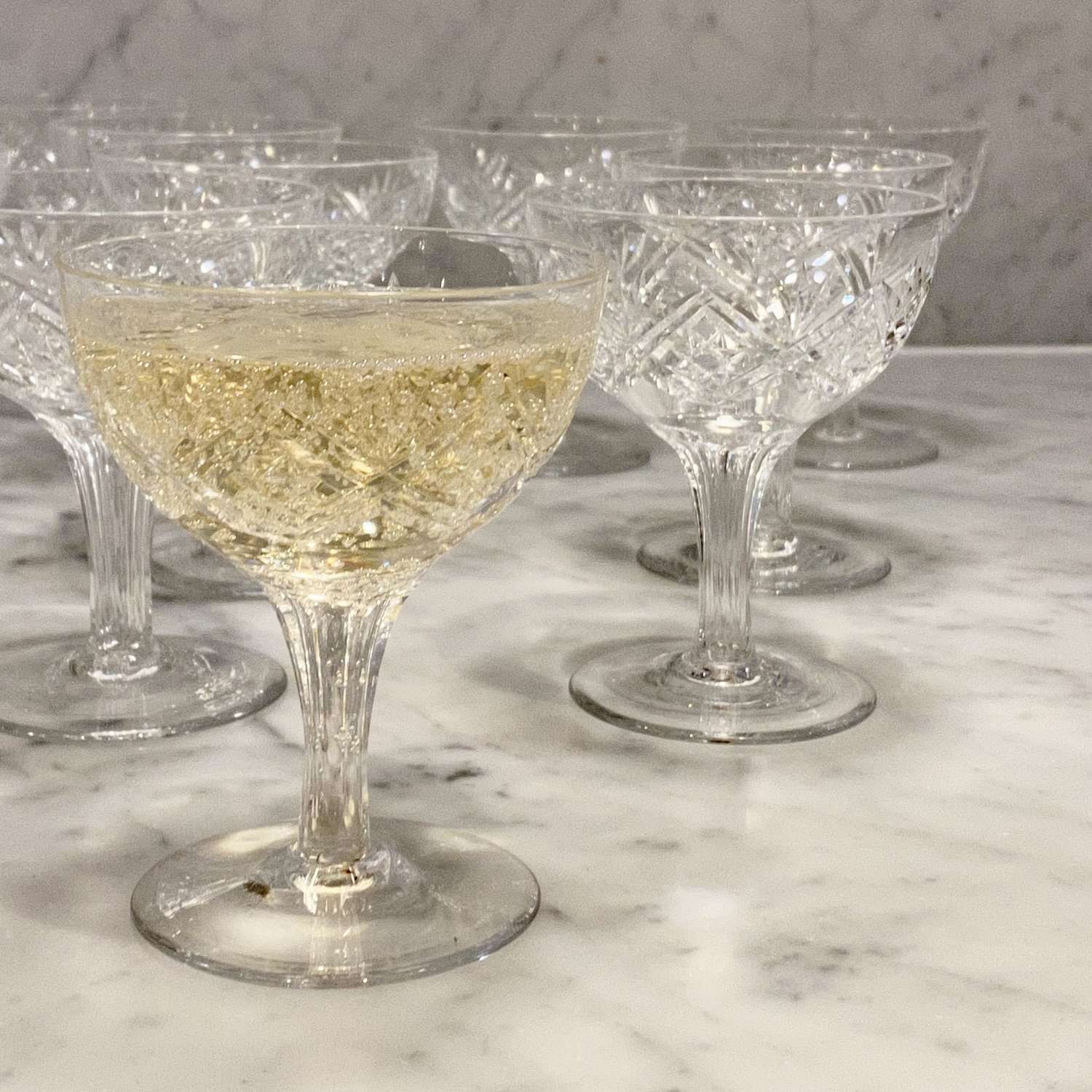 A dozen finest English crystal hollow stem champagne coupes