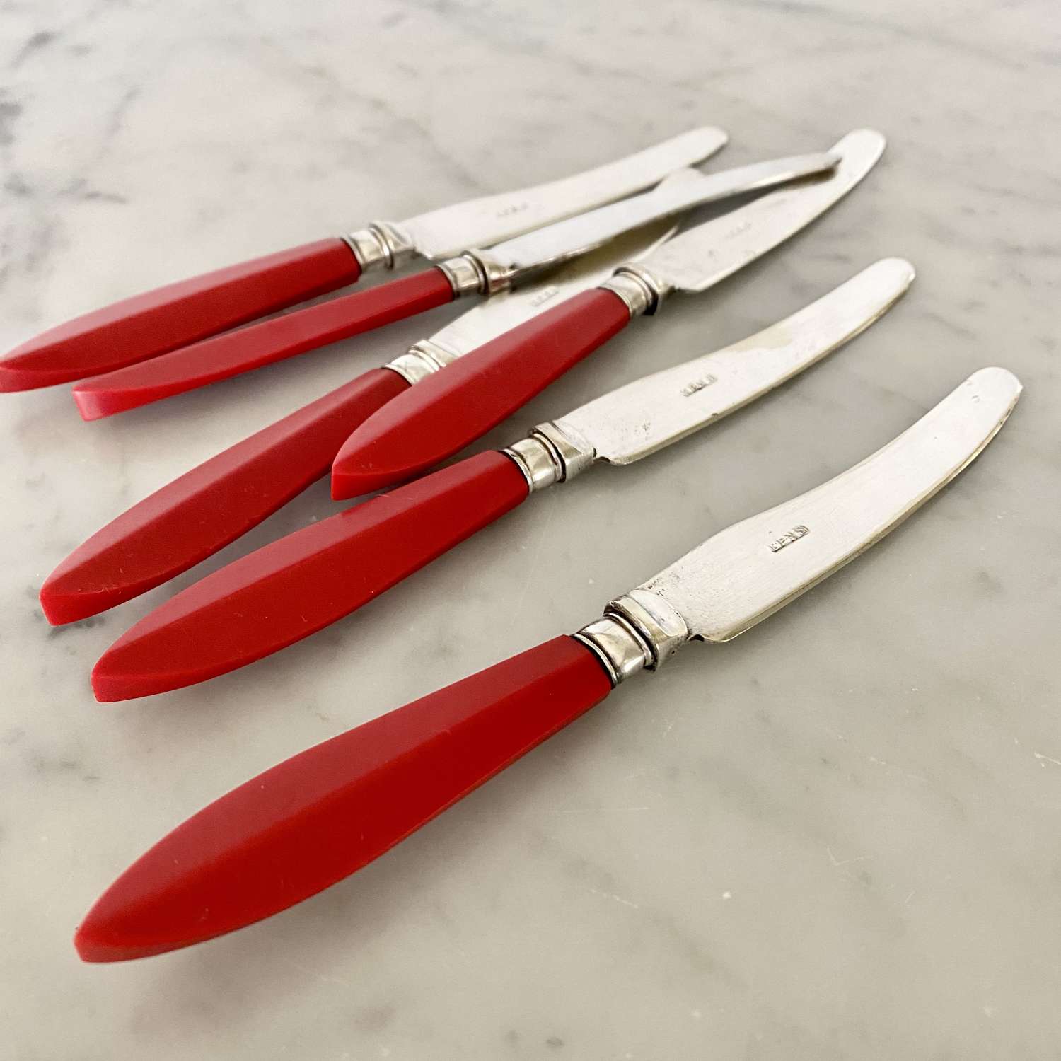 Set of six Art Deco red Bakelite handle butter knives