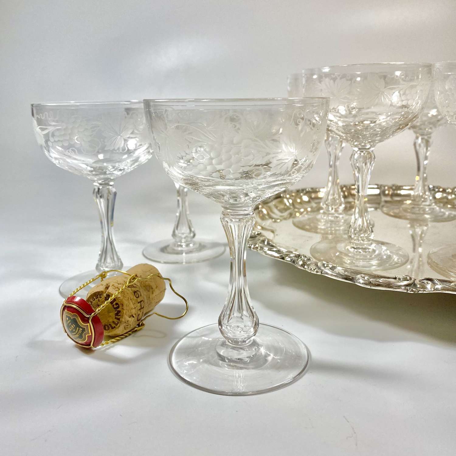 Remarkable set of nine etched crystal champagne coupes