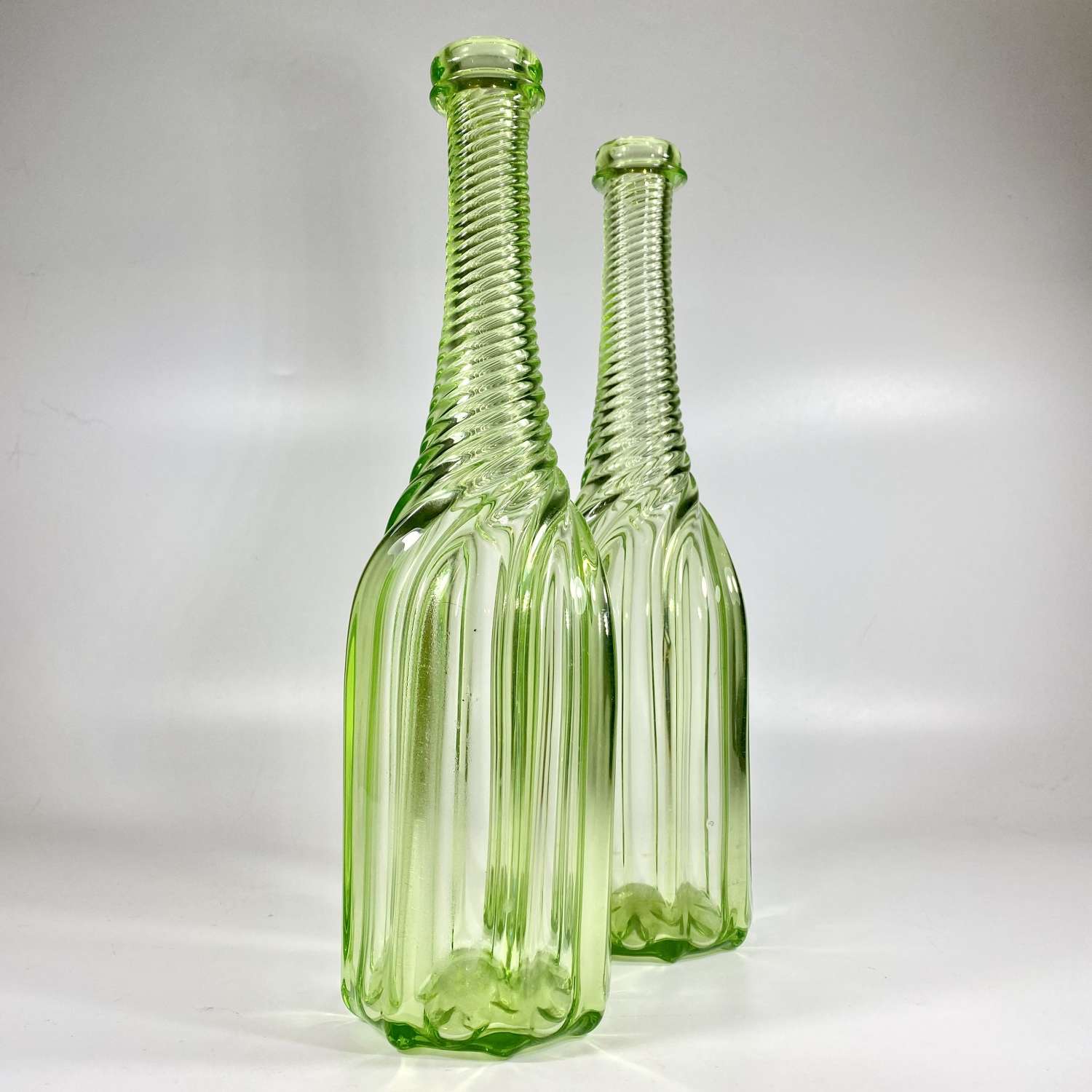 Pair of 19th C wrythen uranium bottle decanters