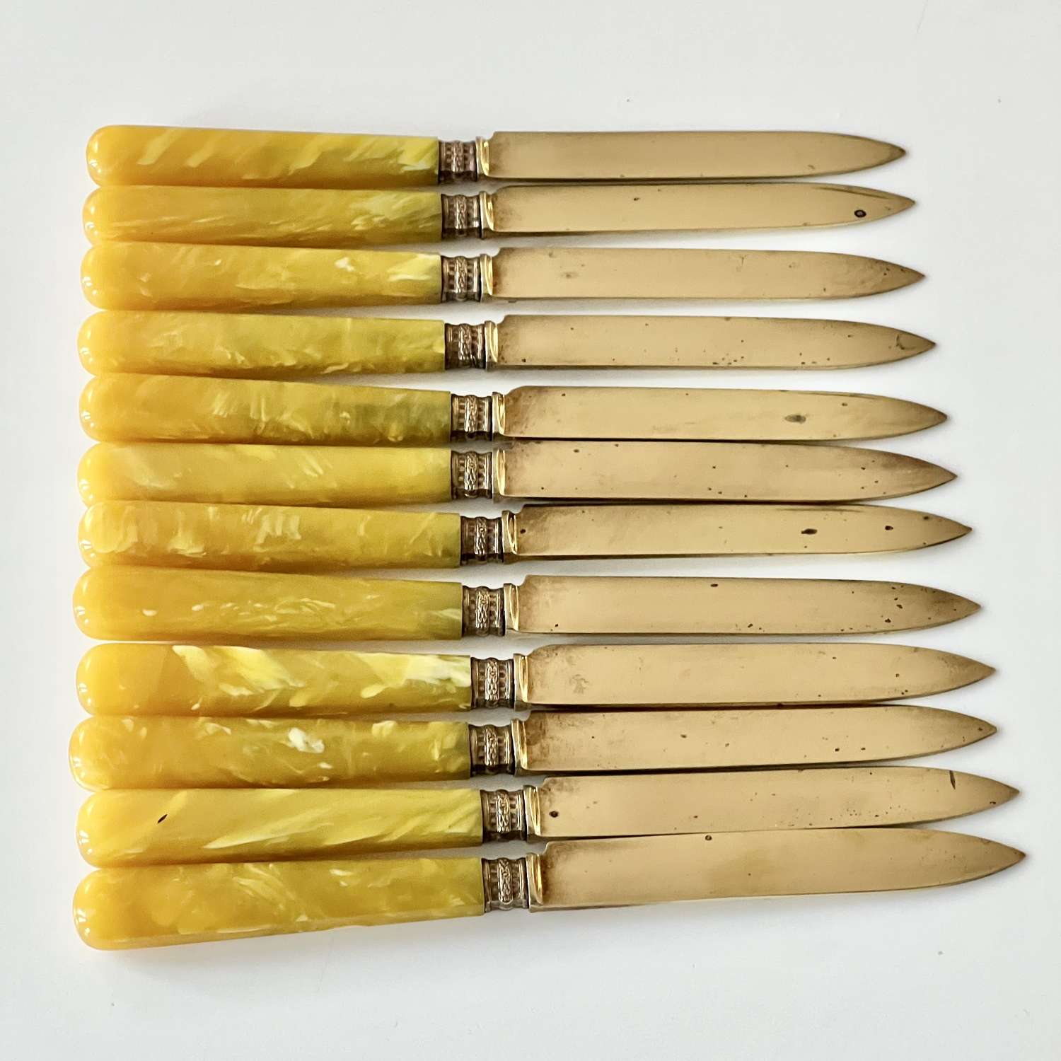 12 Gilt & Butterscotch Bakelite Handled Fruit Knives