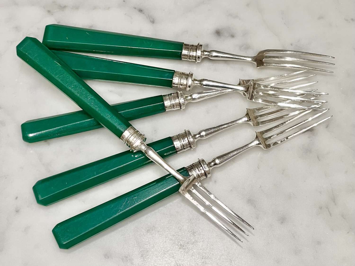 Art Deco silver dessert forks with emerald green handles