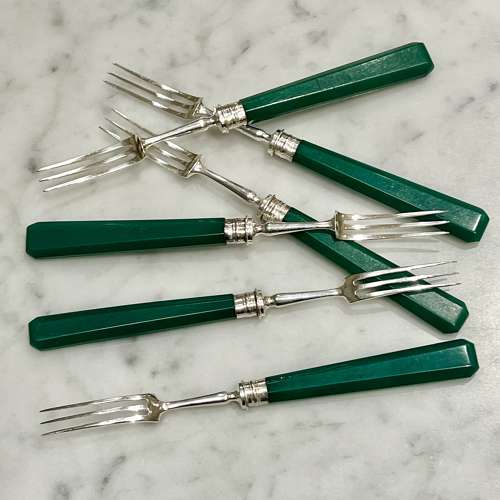 Art Deco silver dessert forks with emerald green handles